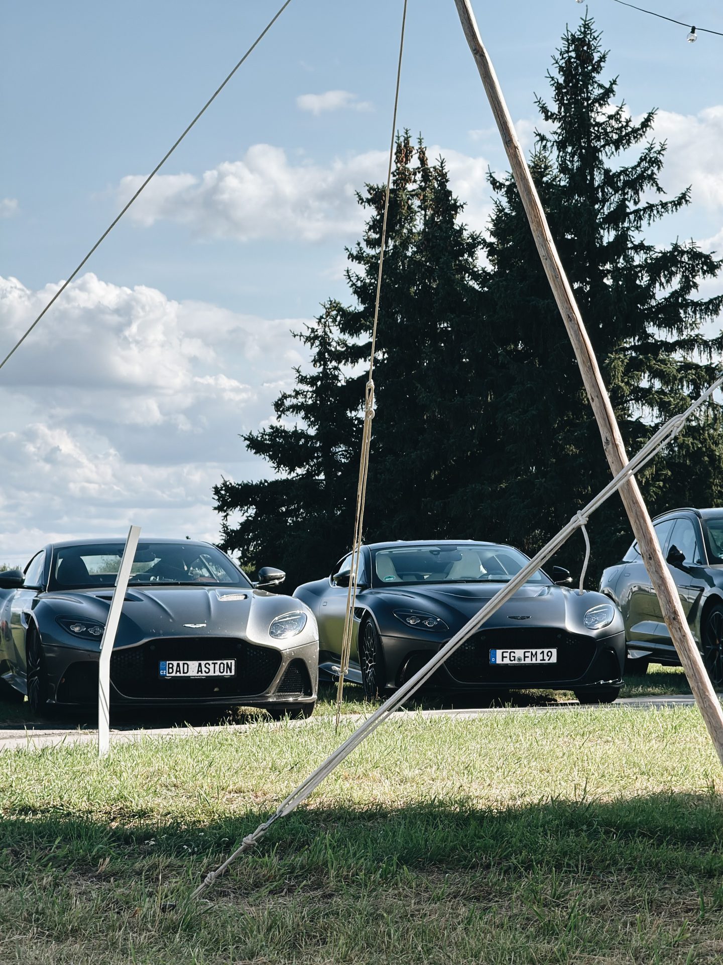 Grüner Aston Martin DBX vor dem Tower des Flugplatzes Großenhain unter einem Sonnensegel